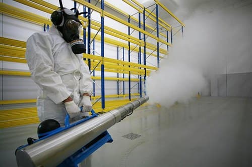 Technician applying a controlled fumigation treatment